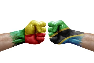Two hands punch to each others on white background. Country flags painted fists, conflict crisis concept between benin and tanzania