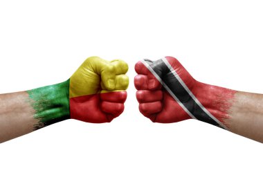 Two hands punch to each others on white background. Country flags painted fists, conflict crisis concept between benin and tobago