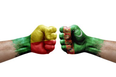 Two hands punch to each others on white background. Country flags painted fists, conflict crisis concept between benin and turkmenistan