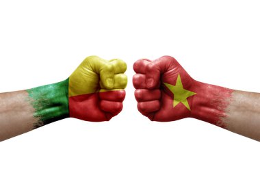 Two hands punch to each others on white background. Country flags painted fists, conflict crisis concept between benin and vietnam