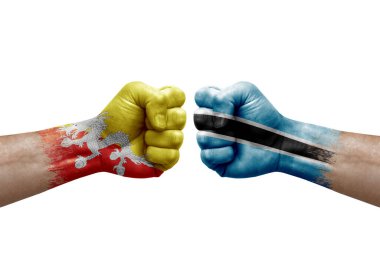 Two hands punch to each others on white background. Country flags painted fists, conflict crisis concept between bhutan and botswana