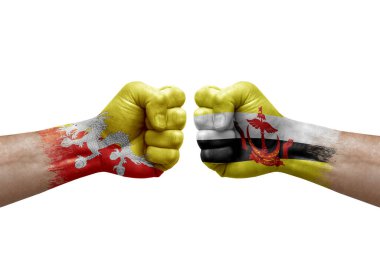 Two hands punch to each others on white background. Country flags painted fists, conflict crisis concept between bhutan and brunei