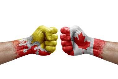 Two hands punch to each others on white background. Country flags painted fists, conflict crisis concept between bhutan and canada
