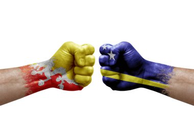 Two hands punch to each others on white background. Country flags painted fists, conflict crisis concept between bhutan and curacao