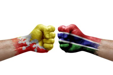 Two hands punch to each others on white background. Country flags painted fists, conflict crisis concept between bhutan and gambia
