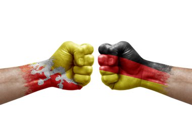 Two hands punch to each others on white background. Country flags painted fists, conflict crisis concept between bhutan and germany