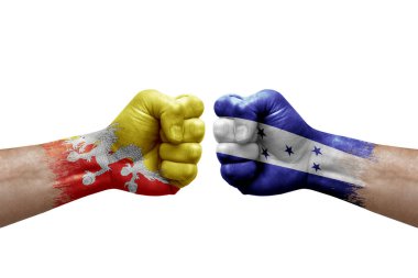 Two hands punch to each others on white background. Country flags painted fists, conflict crisis concept between bhutan and honduras