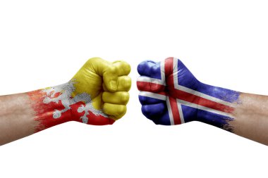 Two hands punch to each others on white background. Country flags painted fists, conflict crisis concept between bhutan and iceland
