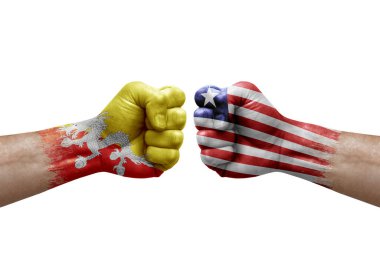 Two hands punch to each others on white background. Country flags painted fists, conflict crisis concept between bhutan and liberia