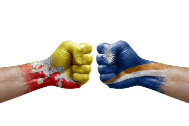 Two hands punch to each others on white background. Country flags painted fists, conflict crisis concept between bhutan and marshall islands