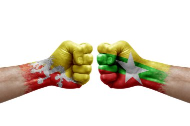 Two hands punch to each others on white background. Country flags painted fists, conflict crisis concept between bhutan and myanmar