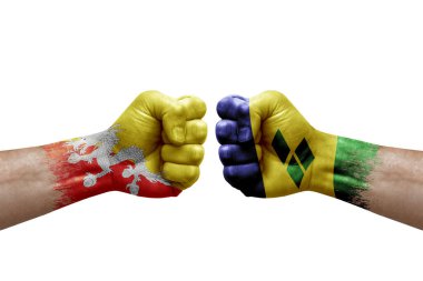 Two hands punch to each others on white background. Country flags painted fists, conflict crisis concept between bhutan and saint vincent and the grenadines