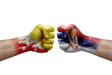 Two hands punch to each others on white background. Country flags painted fists, conflict crisis concept between bhutan and serbia