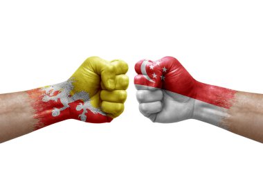 Two hands punch to each others on white background. Country flags painted fists, conflict crisis concept between bhutan and singapore