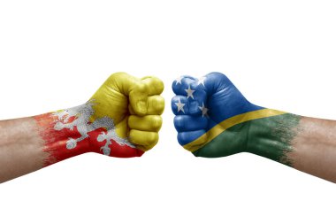 Two hands punch to each others on white background. Country flags painted fists, conflict crisis concept between bhutan and solomon islands
