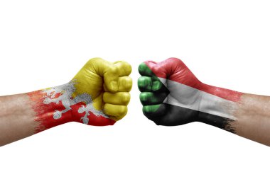 Two hands punch to each others on white background. Country flags painted fists, conflict crisis concept between bhutan and sudan