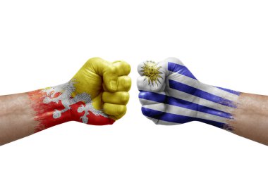 Two hands punch to each others on white background. Country flags painted fists, conflict crisis concept between bhutan and uruguay