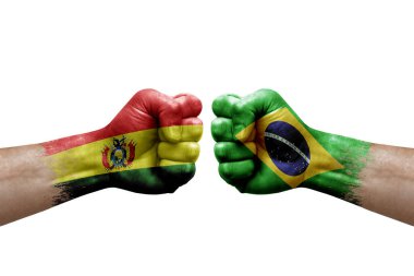 Two hands punch to each others on white background. Country flags painted fists, conflict crisis concept between bolivia and brazil