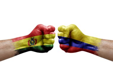 Two hands punch to each others on white background. Country flags painted fists, conflict crisis concept between bolivia and colombia