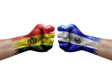 Two hands punch to each others on white background. Country flags painted fists, conflict crisis concept between bolivia and el salvador