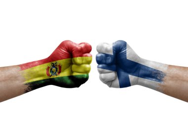 Two hands punch to each others on white background. Country flags painted fists, conflict crisis concept between bolivia and finland