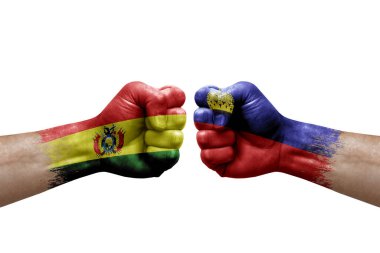 Two hands punch to each others on white background. Country flags painted fists, conflict crisis concept between bolivia and liechtenstein