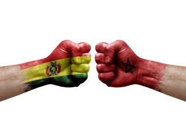Two hands punch to each others on white background. Country flags painted fists, conflict crisis concept between bolivia and morocco