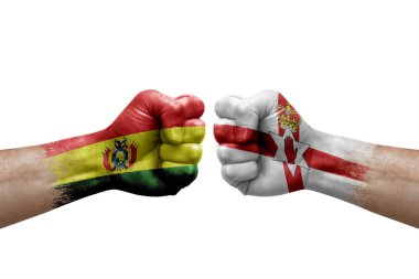 Two hands punch to each others on white background. Country flags painted fists, conflict crisis concept between bolivia and ireland