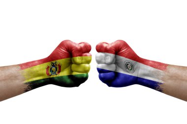 Two hands punch to each others on white background. Country flags painted fists, conflict crisis concept between bolivia and paraguay