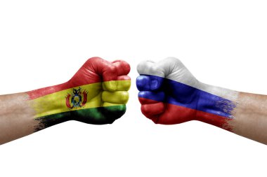Two hands punch to each others on white background. Country flags painted fists, conflict crisis concept between bolivia and russia
