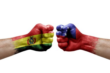 Two hands punch to each others on white background. Country flags painted fists, conflict crisis concept between bolivia and samoa