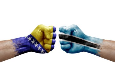 Two hands punch to each others on white background. Country flags painted fists, conflict crisis concept between bosnia and botswana