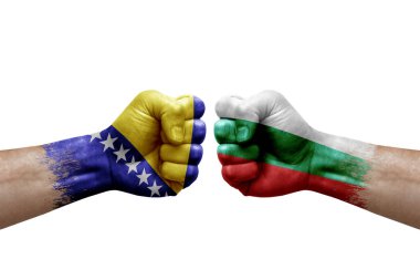Two hands punch to each others on white background. Country flags painted fists, conflict crisis concept between bosnia and bulgaria