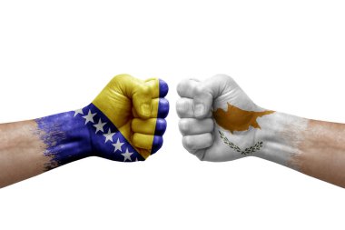 Two hands punch to each others on white background. Country flags painted fists, conflict crisis concept between bosnia and cyprus