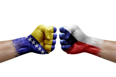 Two hands punch to each others on white background. Country flags painted fists, conflict crisis concept between bosnia and czechia
