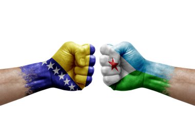 Two hands punch to each others on white background. Country flags painted fists, conflict crisis concept between bosnia and djibouti