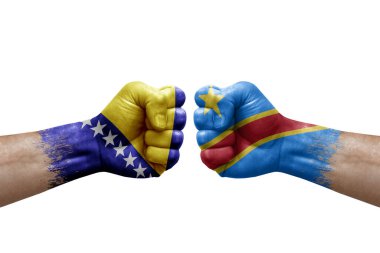 Two hands punch to each others on white background. Country flags painted fists, conflict crisis concept between bosnia and dr congo