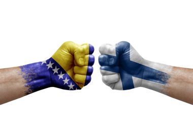 Two hands punch to each others on white background. Country flags painted fists, conflict crisis concept between bosnia and finland