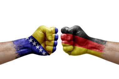 Two hands punch to each others on white background. Country flags painted fists, conflict crisis concept between bosnia and germany