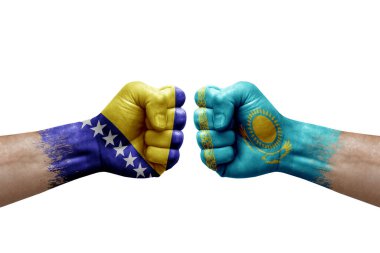 Two hands punch to each others on white background. Country flags painted fists, conflict crisis concept between bosnia and kazakhstan