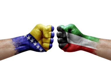 Two hands punch to each others on white background. Country flags painted fists, conflict crisis concept between bosnia and kuwait