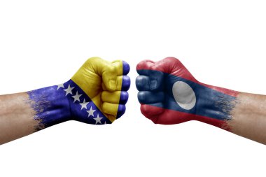 Two hands punch to each others on white background. Country flags painted fists, conflict crisis concept between bosnia and laos