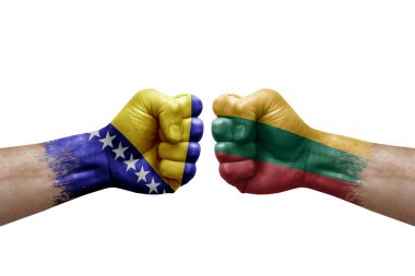 Two hands punch to each others on white background. Country flags painted fists, conflict crisis concept between bosnia and lithuania