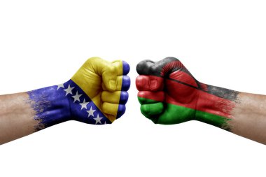 Two hands punch to each others on white background. Country flags painted fists, conflict crisis concept between bosnia and malawi