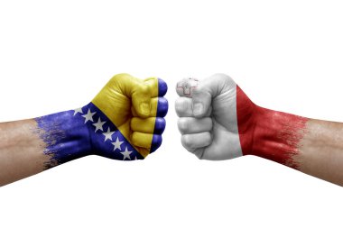 Two hands punch to each others on white background. Country flags painted fists, conflict crisis concept between bosnia and malta