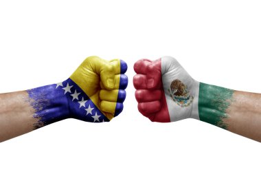 Two hands punch to each others on white background. Country flags painted fists, conflict crisis concept between bosnia and mexico