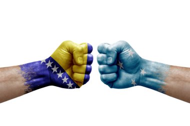 Two hands punch to each others on white background. Country flags painted fists, conflict crisis concept between bosnia and micronesia