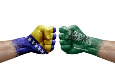 Two hands punch to each others on white background. Country flags painted fists, conflict crisis concept between bosnia and saudi arabia