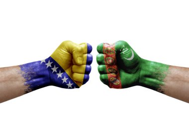 Two hands punch to each others on white background. Country flags painted fists, conflict crisis concept between bosnia and turkmenistan