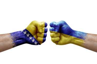 Two hands punch to each others on white background. Country flags painted fists, conflict crisis concept between bosnia and ukraine